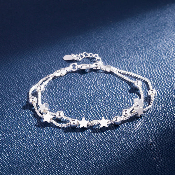 Silver Pentagram Star Bracelet displayed on a blue background, featuring stars and beads in a detailed design.