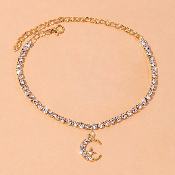 Star Moon Anklet featuring sparkling crystals and a crescent moon charm on a gold chain.