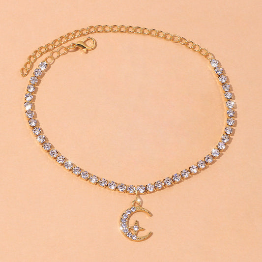 Star Moon Anklet featuring sparkling crystals and a crescent moon charm on a gold chain.