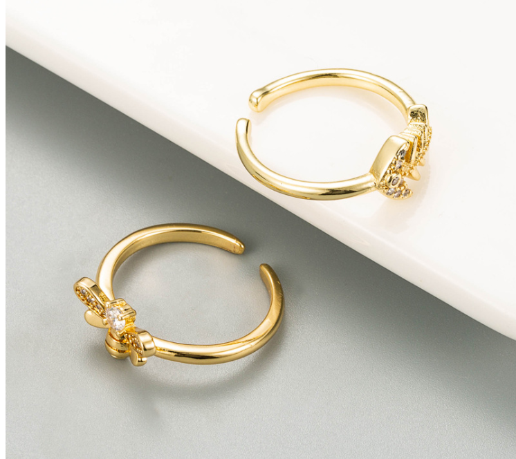 Golden Bee Fishbone Ring displayed on a minimalist background, showcasing its unique design and elegant finish.