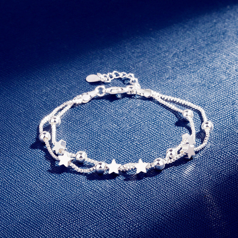 Silver Pentagram Star Bracelet featuring star and bead details on a blue background.