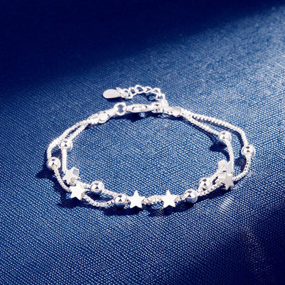 Silver Pentagram Star Bracelet featuring star and bead details on a blue background.